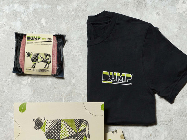 Bump Burger Packaging, Bump Branded T-Shirt and Bump Marketing Post Card on Grey Surface