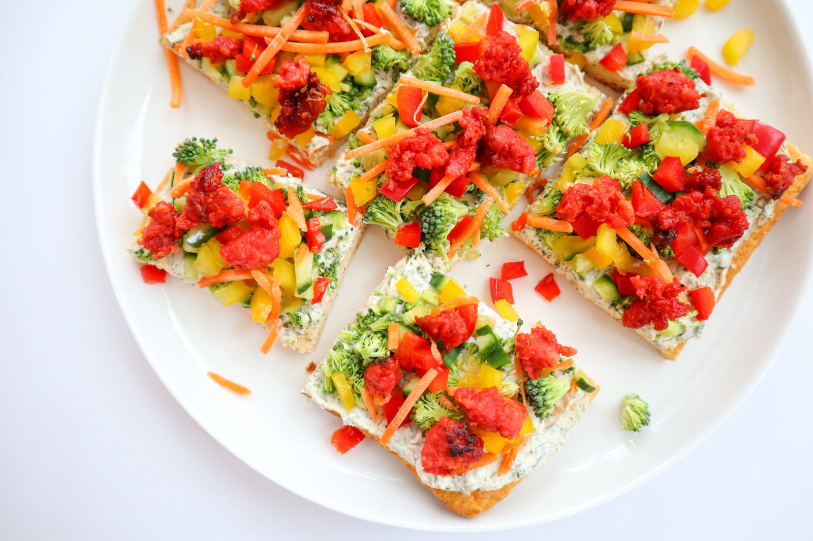 Brightly coloured veggie pizza, with Bump sausage