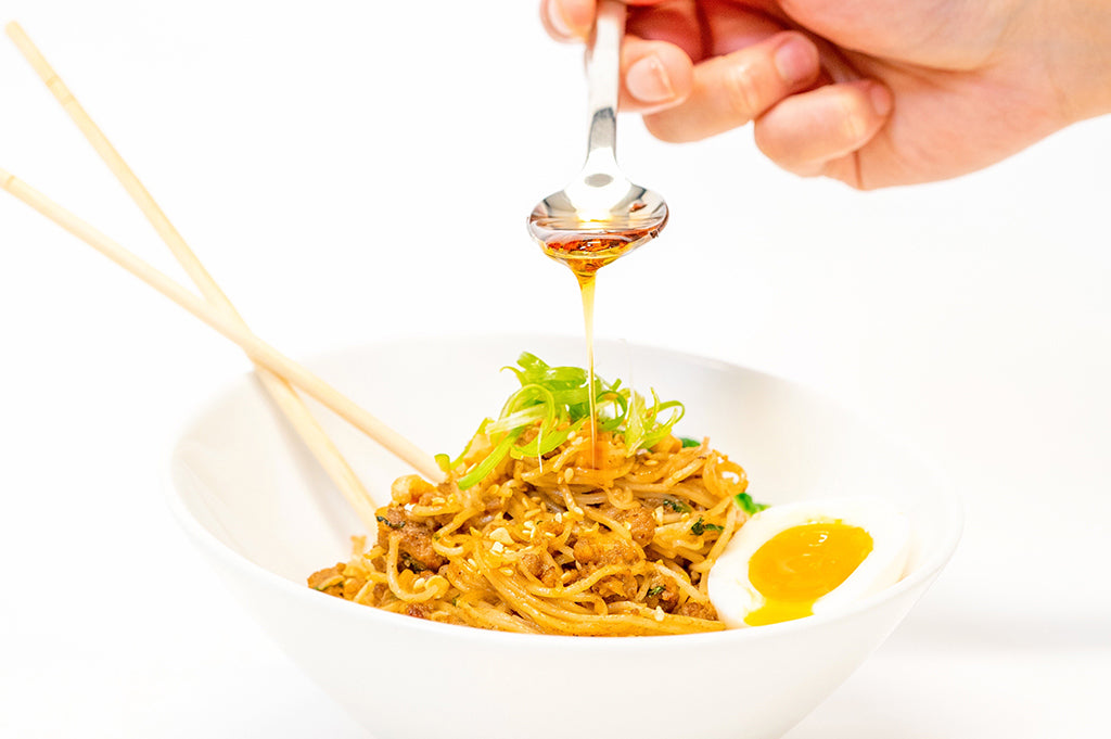 Hand Spooning Dan Dan Noodle Bowl