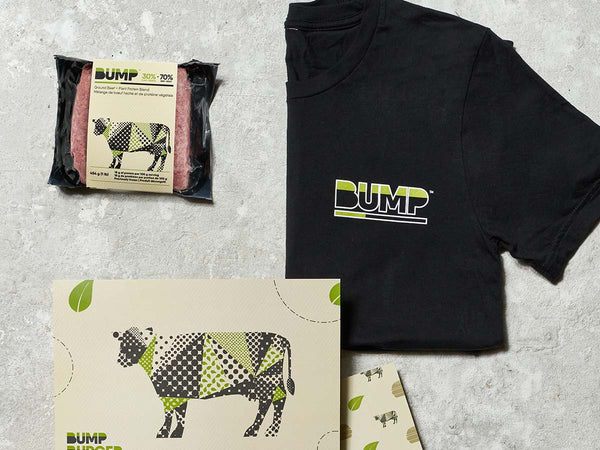 Bump Burger Packaging, Bump Branded T-Shirt and Bump Marketing Post Card on Grey Surface
