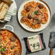 Spaghetti Dinner for Two with Single Package of Bump Plant-Enhanced Beer on Grey Slate Table