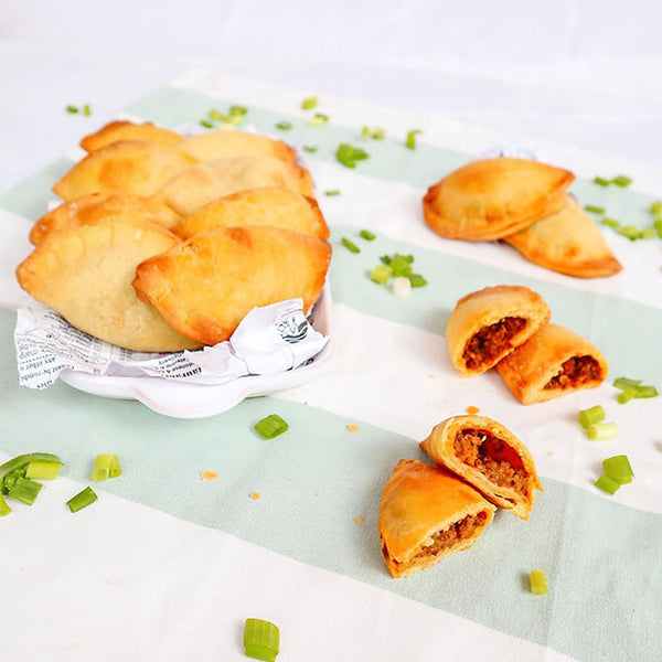 Plate of cooked Jamaican patties.